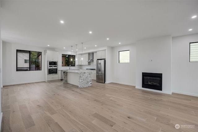 unfurnished living room featuring sink and light wood-type flooring