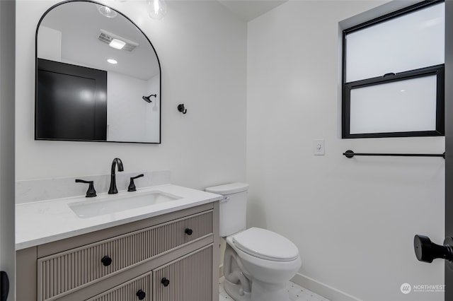 bathroom with vanity and toilet