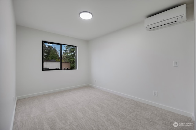 carpeted spare room featuring an AC wall unit