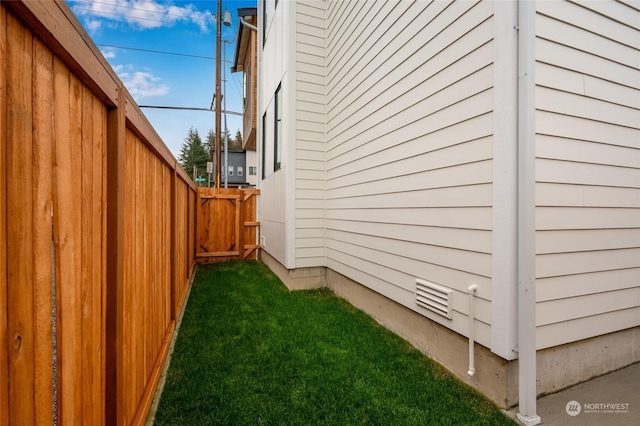 view of side of home with a yard