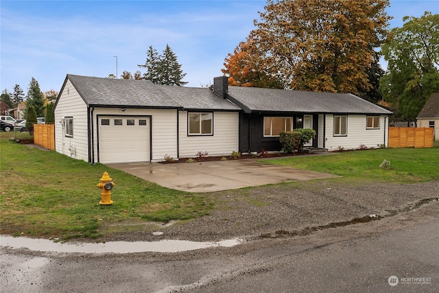 single story home featuring a garage and a front yard