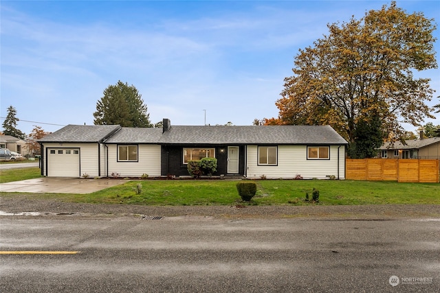 single story home featuring a garage and a front yard