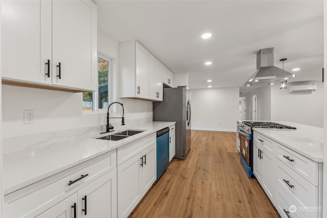 kitchen featuring stainless steel appliances, sink, white cabinets, island exhaust hood, and light wood-type flooring