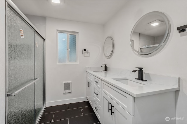 bathroom featuring heating unit, an enclosed shower, vanity, and tile patterned flooring