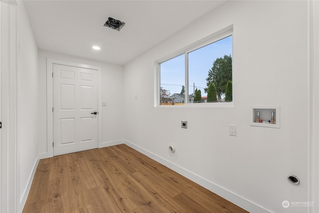 laundry room featuring washer hookup, light hardwood / wood-style floors, and hookup for an electric dryer