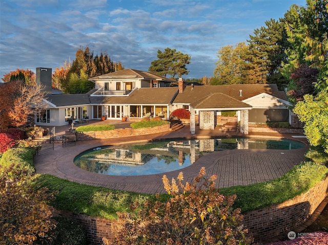 back of house with a balcony and a patio