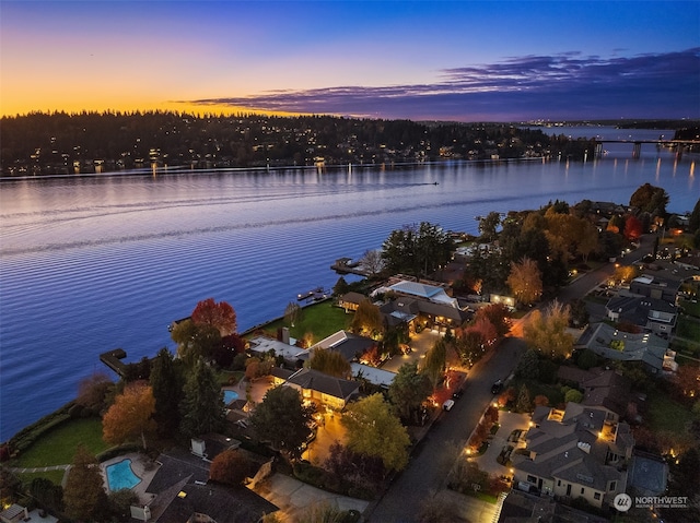 aerial view at dusk with a water view