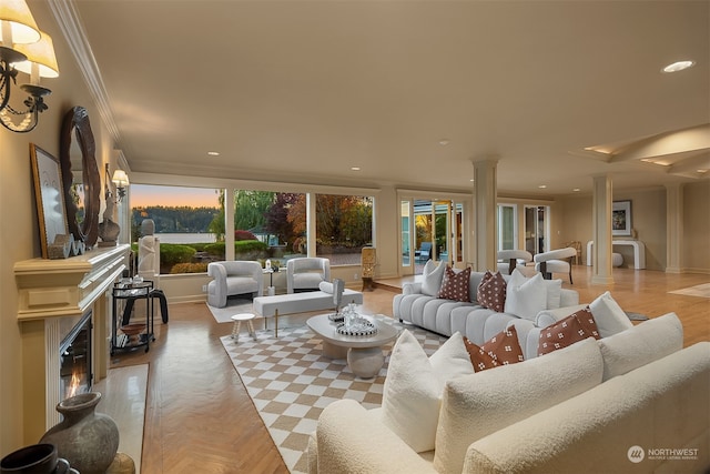 living room featuring ornate columns, crown molding, and light parquet flooring