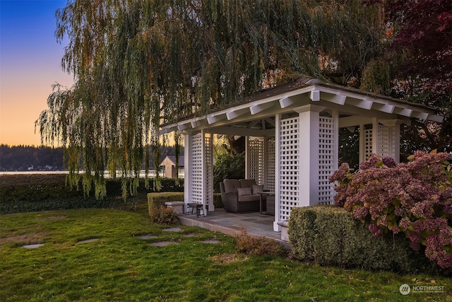 yard at dusk with a gazebo and a patio area