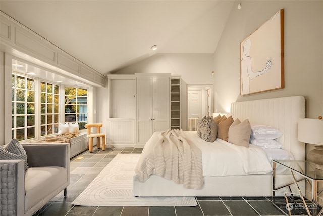 tiled bedroom featuring high vaulted ceiling