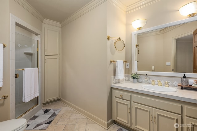 bathroom with toilet, vanity, ornamental molding, and walk in shower