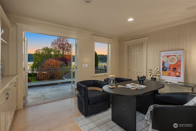 interior space featuring light wood-type flooring and crown molding