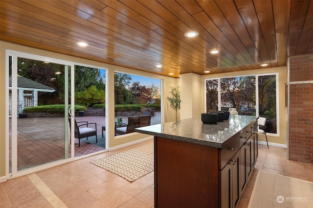 interior space with a healthy amount of sunlight and wooden ceiling