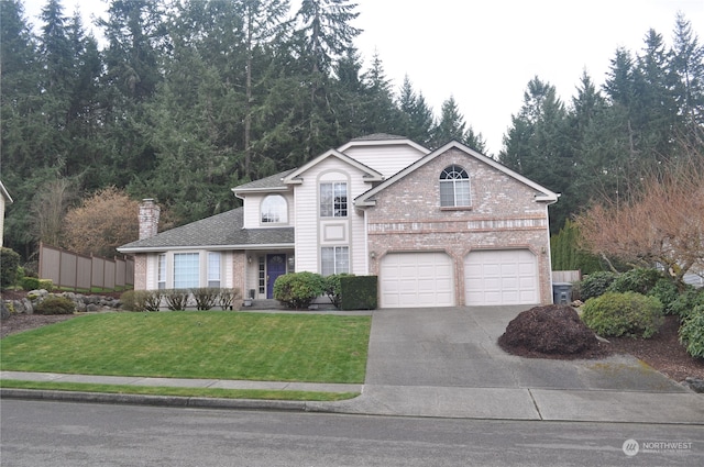 view of front property with a garage and a front yard