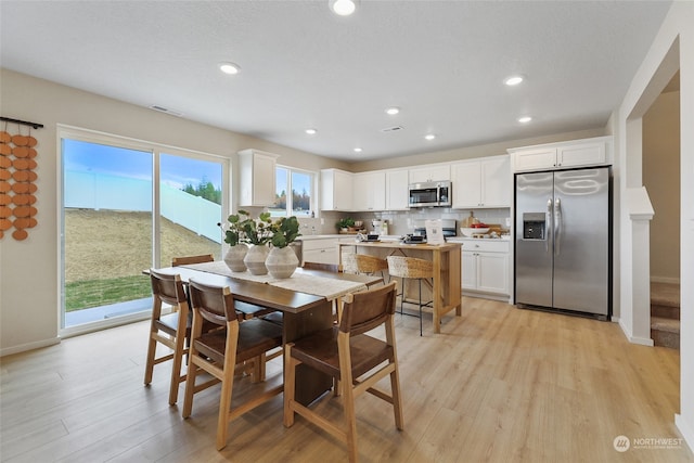 dining space featuring light wood-type flooring