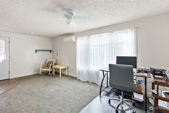 office featuring a textured ceiling, ceiling fan, a healthy amount of sunlight, and a wall mounted air conditioner