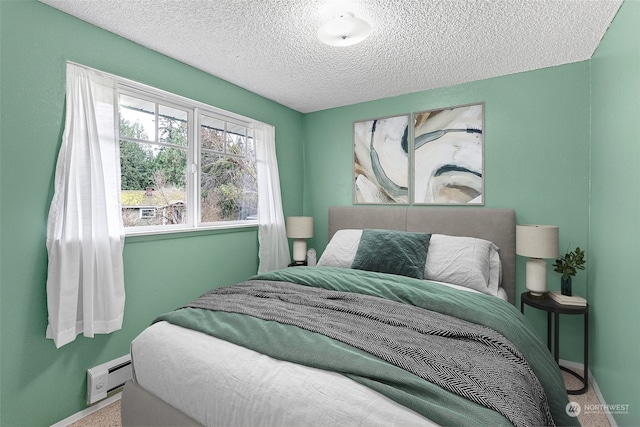 bedroom featuring carpet flooring, a textured ceiling, and a baseboard radiator