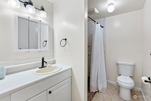 bathroom with tile patterned flooring, toilet, vanity, and walk in shower