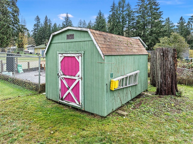 view of outbuilding featuring a lawn