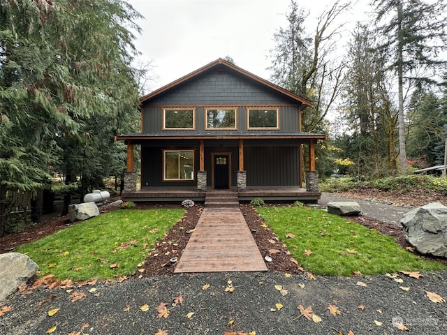 111 Heather Pl, Packwood, WA 98361 - chalet / cabin featuring covered porch, stone siding, and a front yard