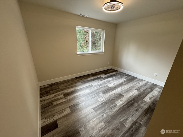 empty room with hardwood / wood-style flooring