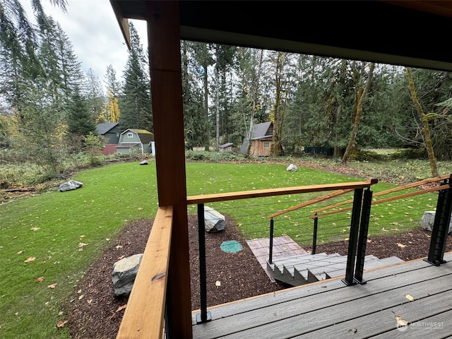 wooden terrace featuring a lawn