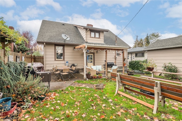 back of house featuring a patio area and an outdoor living space