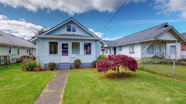 bungalow-style home with a front yard