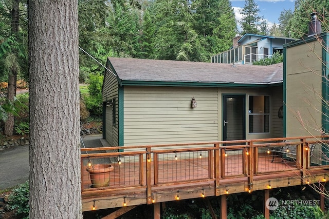 back of property featuring a wooden deck