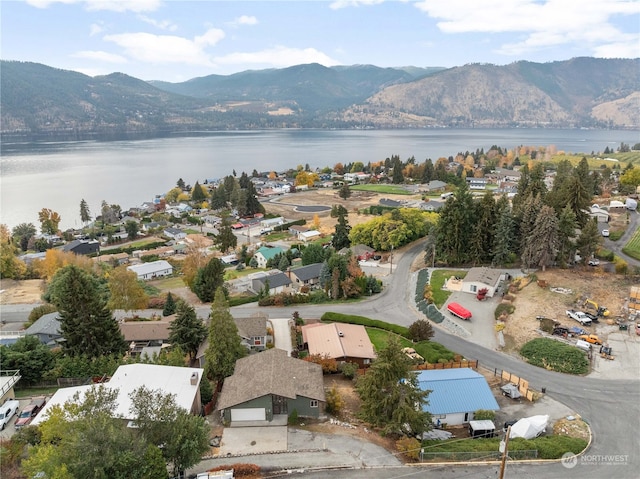 birds eye view of property featuring a water and mountain view