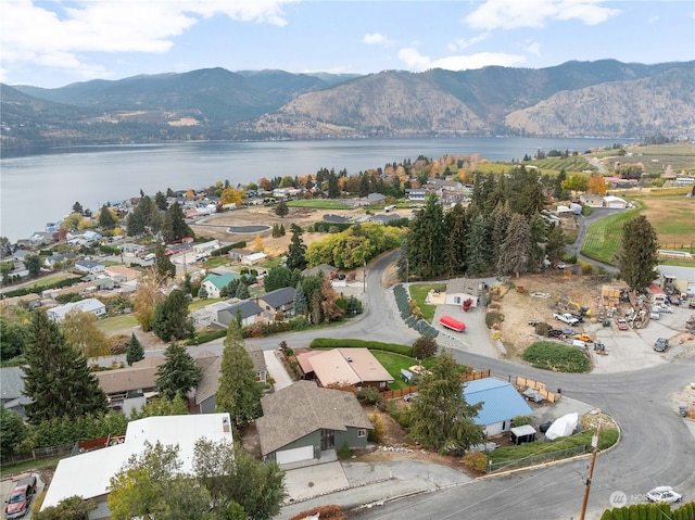 drone / aerial view featuring a water and mountain view