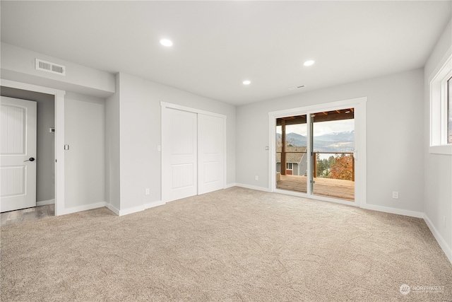 unfurnished bedroom with a closet, access to outside, and carpet