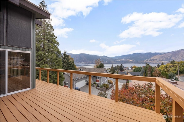 deck with a water and mountain view