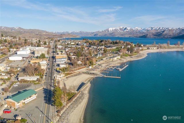 drone / aerial view with a water and mountain view