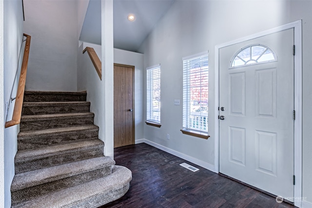 entryway featuring high vaulted ceiling and dark hardwood / wood-style flooring