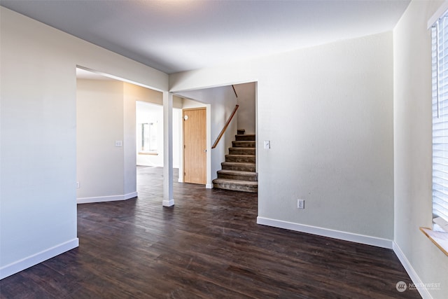 unfurnished room with dark hardwood / wood-style floors