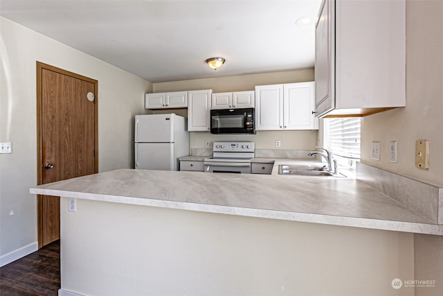 kitchen with dark hardwood / wood-style flooring, white cabinets, kitchen peninsula, sink, and white appliances