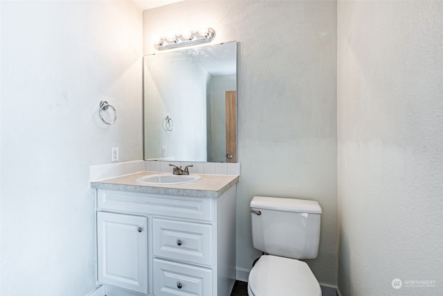 bathroom with toilet and vanity