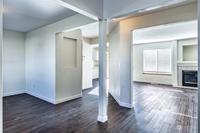 interior space with dark hardwood / wood-style floors and a tile fireplace