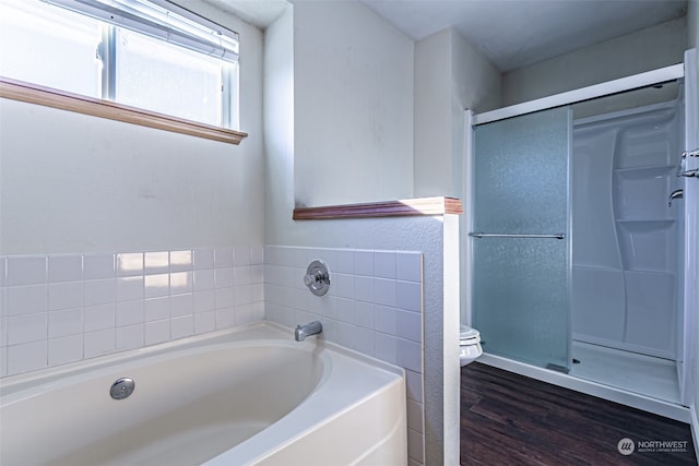 bathroom with hardwood / wood-style flooring, toilet, and plus walk in shower