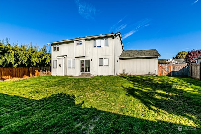 rear view of house with a lawn