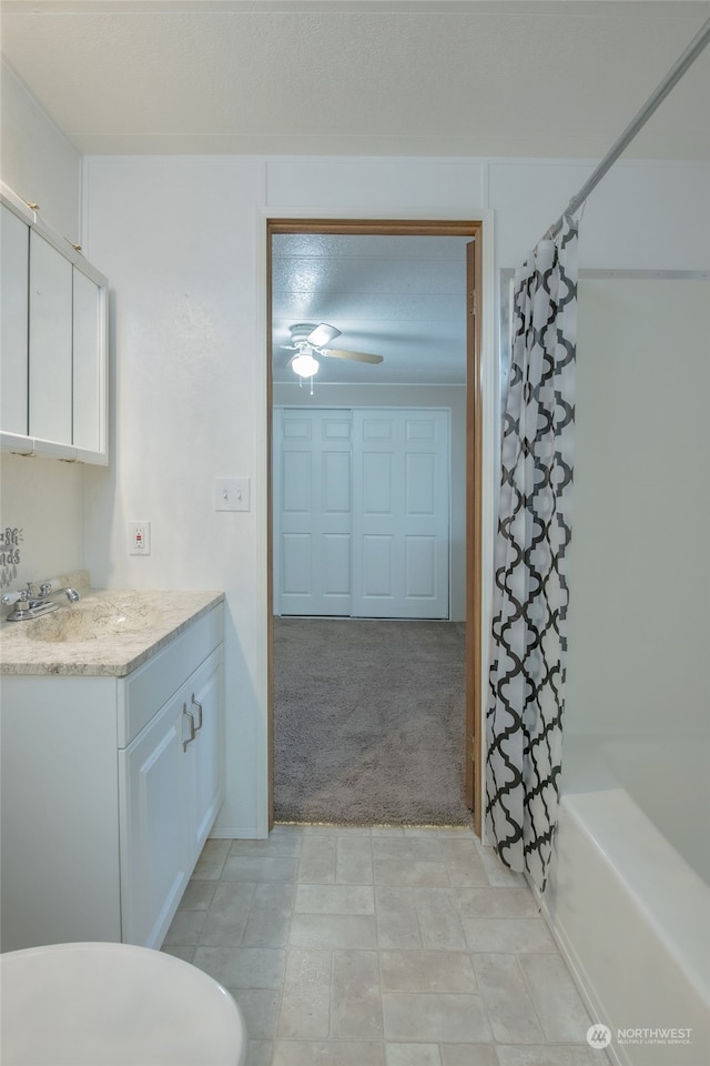 bathroom with vanity, shower / bath combination with curtain, and ceiling fan