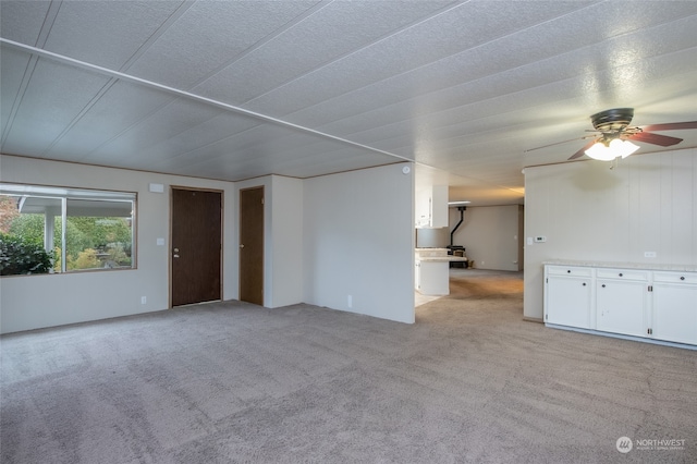 unfurnished room featuring ceiling fan and light carpet