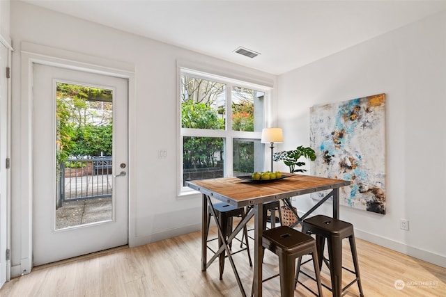 dining room with plenty of natural light and light hardwood / wood-style floors