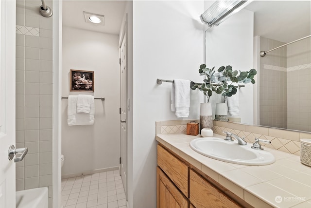 bathroom featuring tile patterned floors, vanity, and toilet