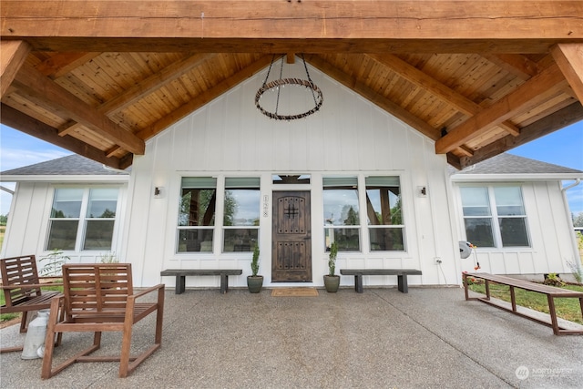 view of exterior entry with a patio area