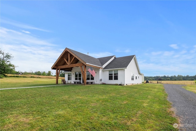 view of front facade with a front lawn and a rural view