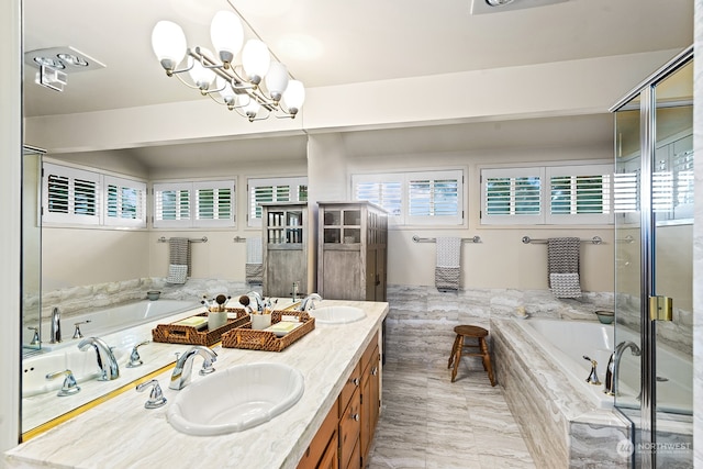 bathroom with plus walk in shower, vanity, and an inviting chandelier