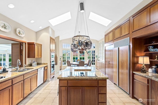 kitchen with sink, built in appliances, pendant lighting, a center island with sink, and light tile patterned floors