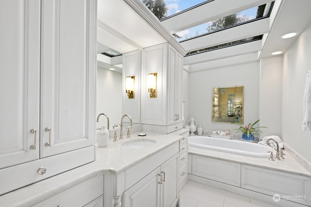 bathroom featuring tile patterned floors, a washtub, vanity, and a skylight